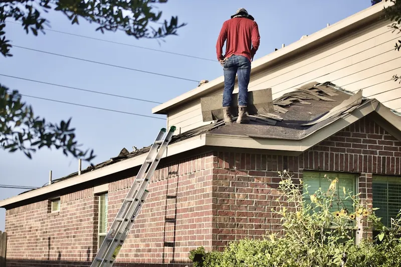 Professional roofer working on a residential roof in Annie Laurie Gardens